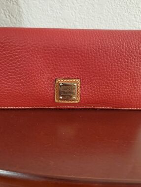 Dooney & Bourke Red Pebbled Leather Continental Wallet with Gold Plaque